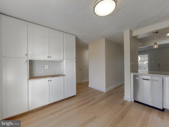 kitchen with dishwasher, hanging light fixtures, a textured ceiling, decorative backsplash, and white cabinets