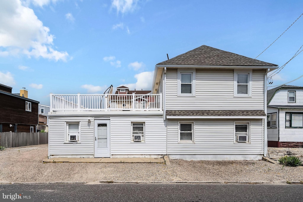 back of house with a balcony