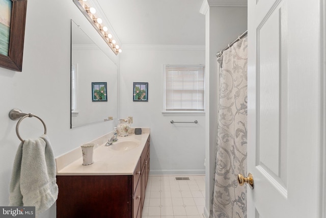 full bath featuring visible vents, vanity, baseboards, ornamental molding, and tile patterned floors