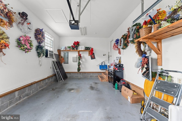 garage with electric panel, cooling unit, and a garage door opener