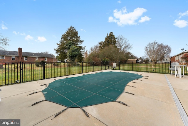 view of swimming pool with a patio, a lawn, and a fenced in pool