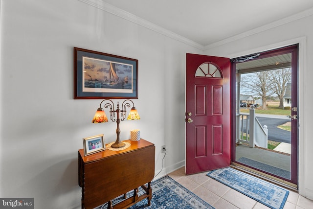 entrance foyer featuring ornamental molding, baseboards, and light tile patterned floors