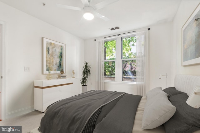 bedroom with light carpet and ceiling fan