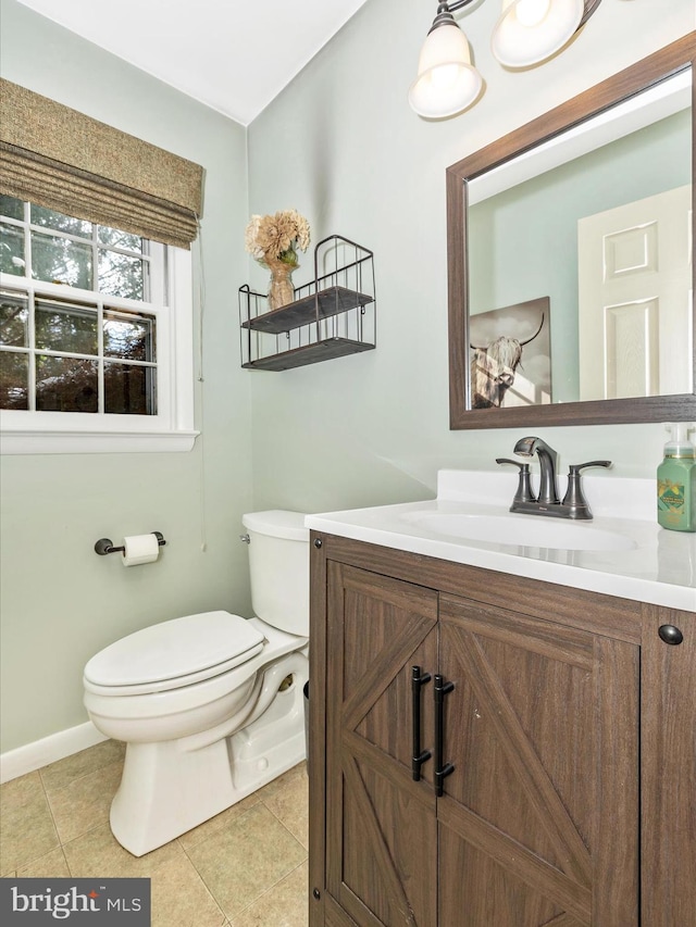 bathroom with tile patterned flooring, vanity, and toilet