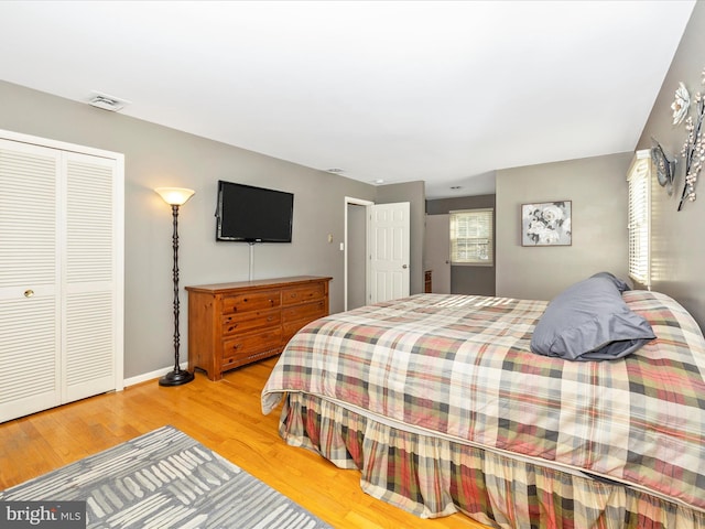 bedroom with a closet and light hardwood / wood-style floors