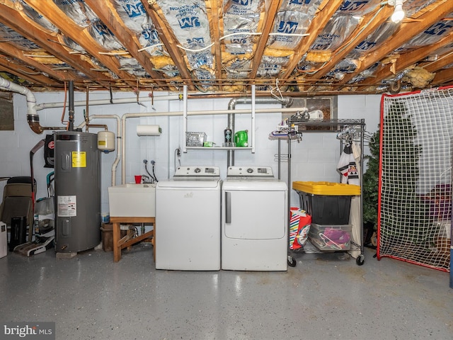 basement featuring washing machine and dryer, water heater, and sink