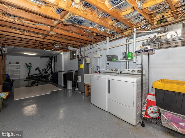 basement featuring washer and clothes dryer and water heater