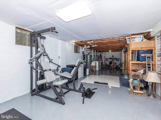 workout area with washer and clothes dryer and gas water heater