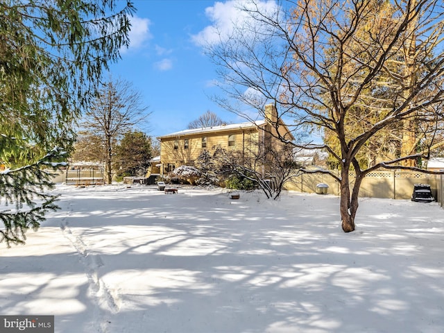 view of yard layered in snow