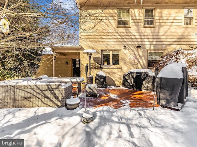 view of snow covered rear of property