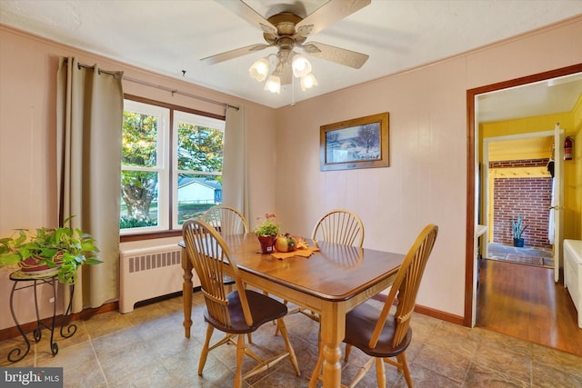 dining room with ceiling fan, radiator heating unit, and crown molding