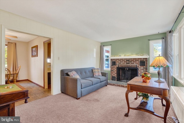 carpeted living room with a fireplace and radiator heating unit