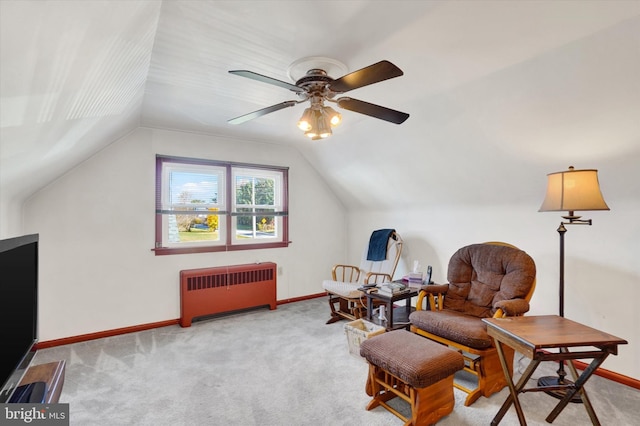 sitting room with radiator heating unit, light colored carpet, vaulted ceiling, and ceiling fan