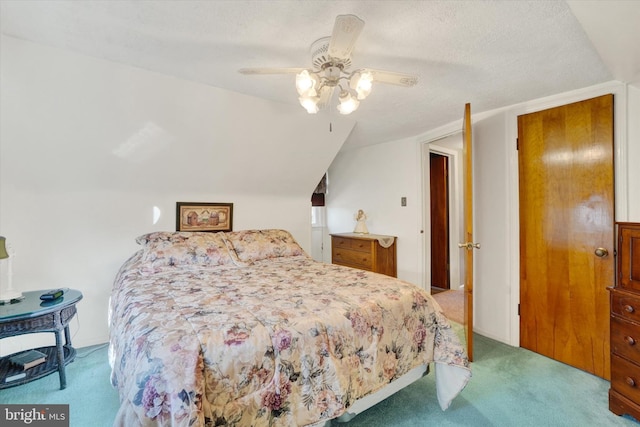 bedroom with a textured ceiling, light colored carpet, ceiling fan, and lofted ceiling