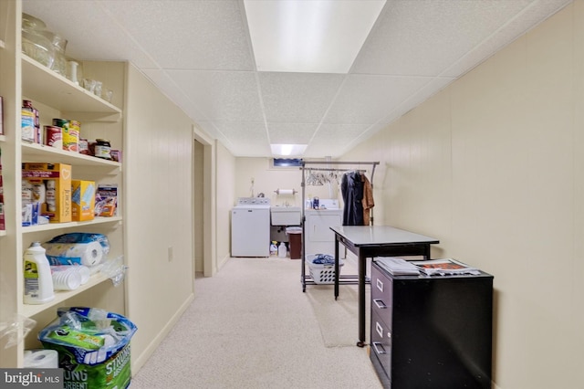 interior space featuring light carpet, a paneled ceiling, sink, and washing machine and clothes dryer