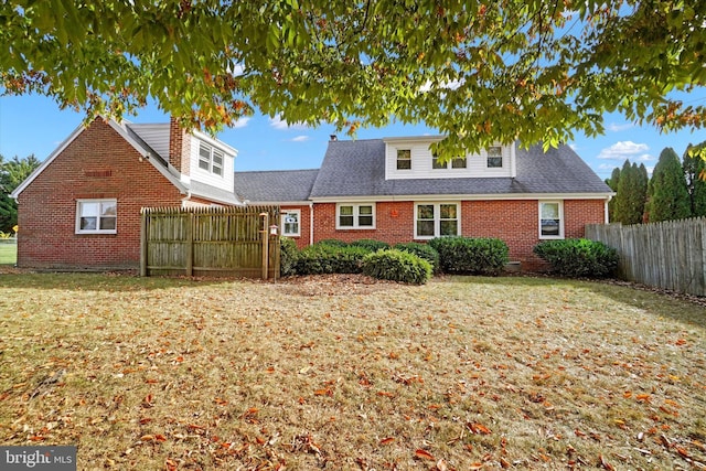 rear view of property featuring a yard