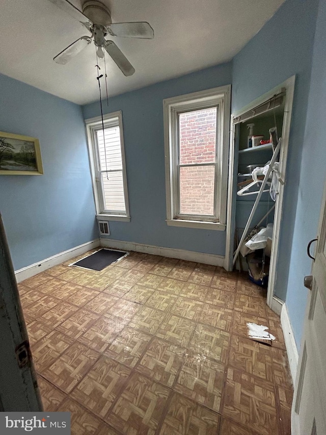 spare room featuring ceiling fan and light parquet floors