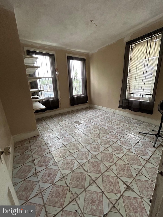 interior space featuring a textured ceiling and light tile patterned flooring