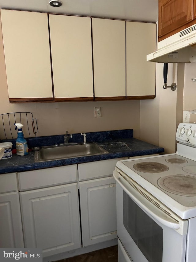 kitchen featuring white cabinets, white range with electric stovetop, and sink