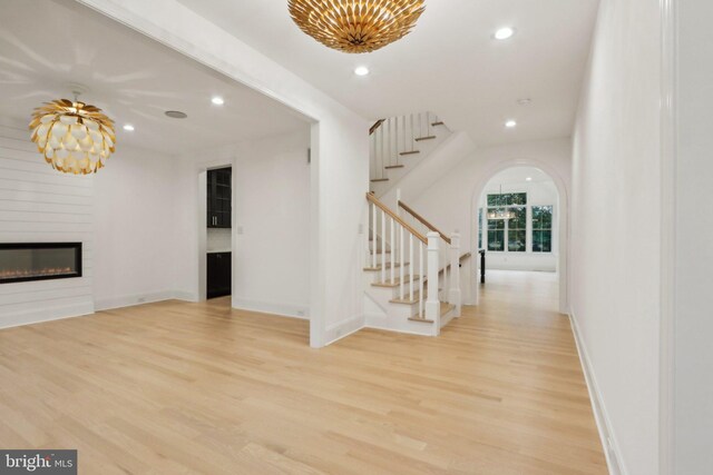 interior space with a large fireplace and light hardwood / wood-style flooring