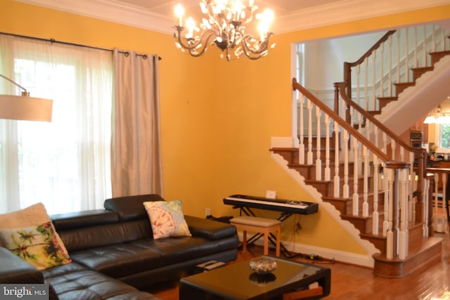 living room with stairway, an inviting chandelier, and ornamental molding