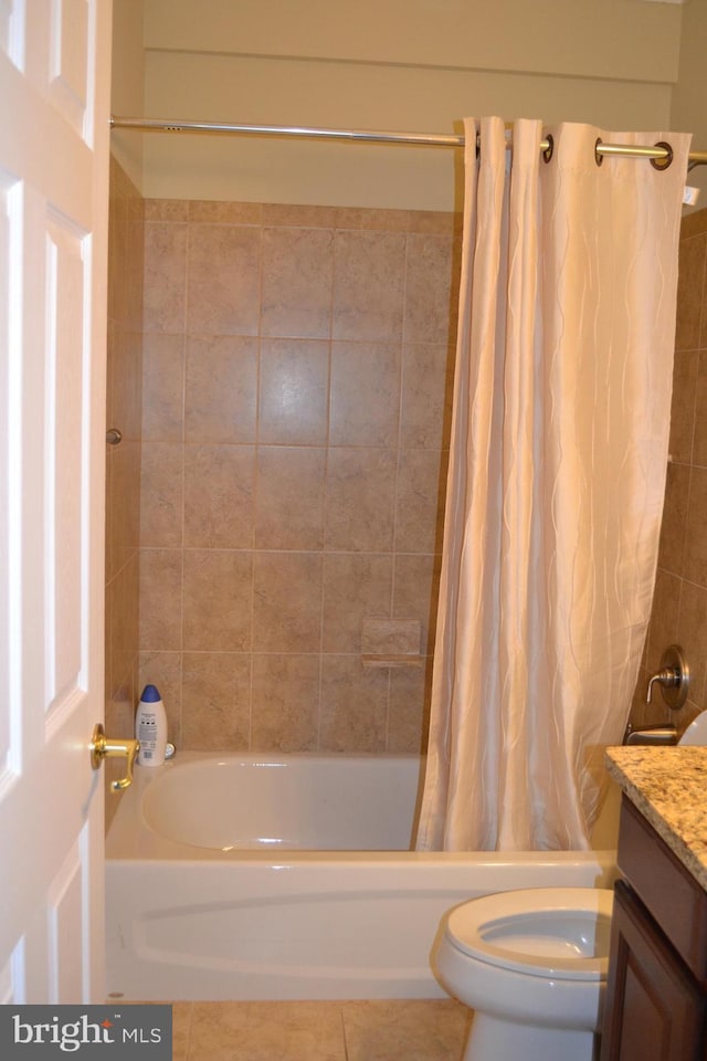 full bathroom featuring tile patterned floors, shower / tub combo with curtain, vanity, and toilet