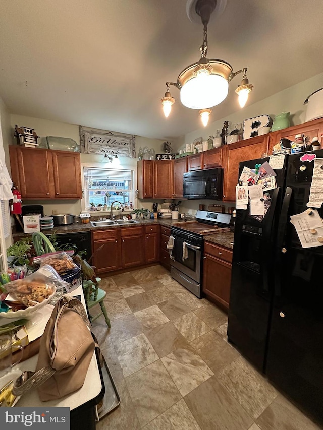 kitchen featuring black appliances, brown cabinetry, dark countertops, and a sink