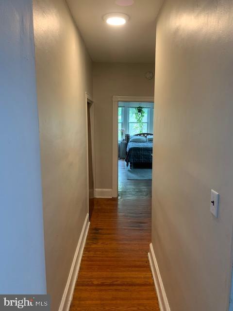 hall with dark hardwood / wood-style flooring