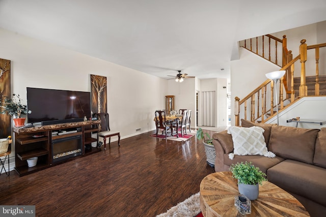 living room featuring hardwood / wood-style floors and ceiling fan