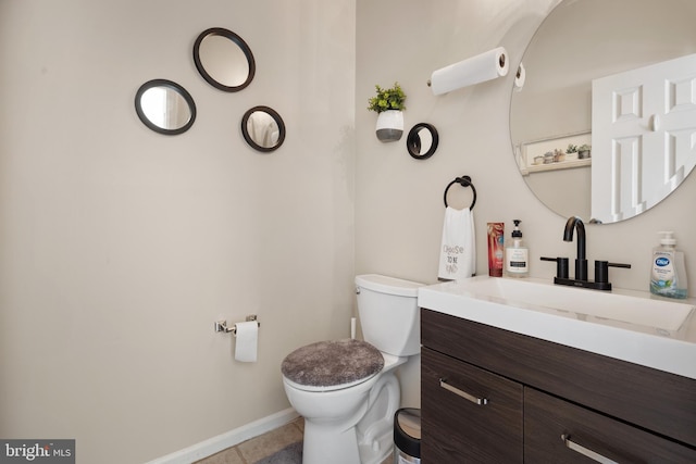 bathroom with tile patterned floors, vanity, and toilet