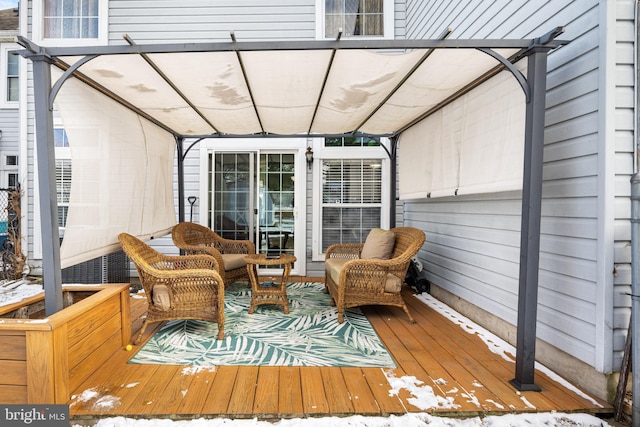 wooden deck with an outdoor hangout area and a pergola