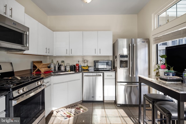 kitchen featuring white cabinetry, sink, and stainless steel appliances