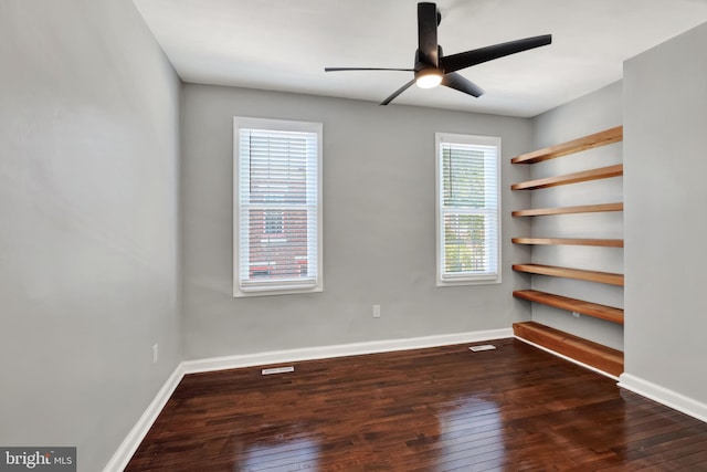 empty room featuring ceiling fan and dark hardwood / wood-style flooring