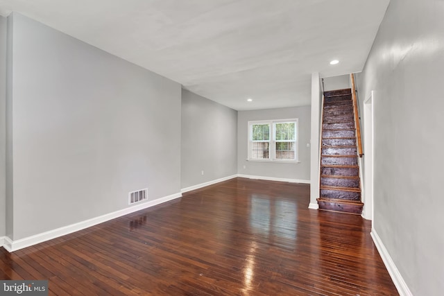 unfurnished living room with dark hardwood / wood-style flooring