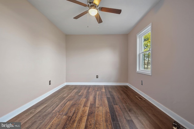 spare room featuring dark hardwood / wood-style flooring and ceiling fan