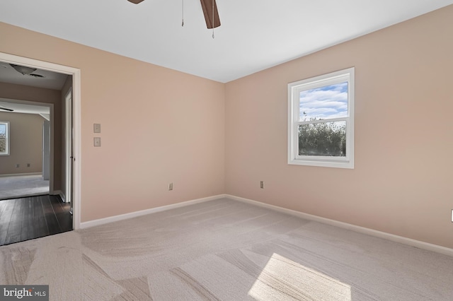 carpeted empty room featuring ceiling fan