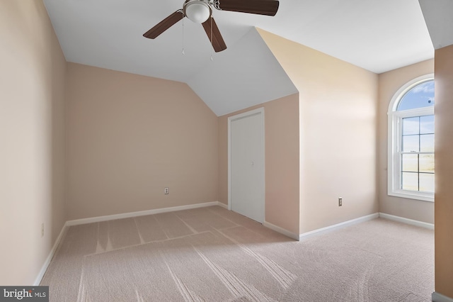 bonus room featuring ceiling fan, light colored carpet, and lofted ceiling