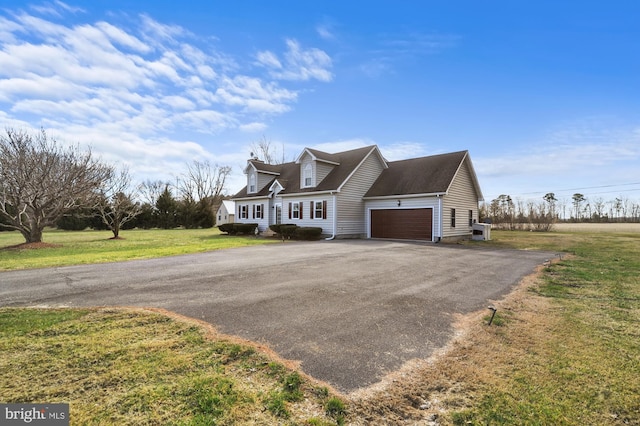 new england style home featuring a garage and a front yard