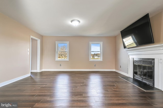 unfurnished living room featuring dark hardwood / wood-style flooring