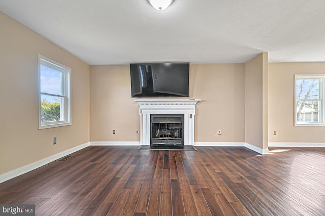 unfurnished living room featuring dark wood-type flooring