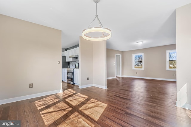 unfurnished living room featuring dark wood-type flooring