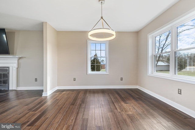 unfurnished dining area featuring dark wood-type flooring