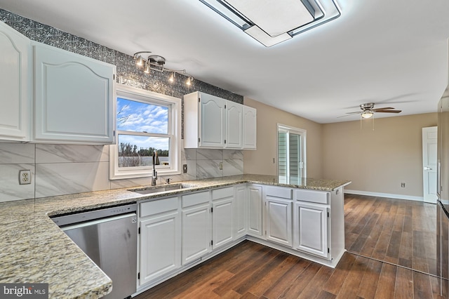 kitchen with kitchen peninsula, white cabinetry, stainless steel dishwasher, and sink