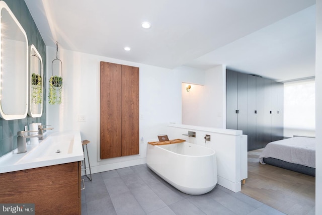 bathroom with vanity and a tub