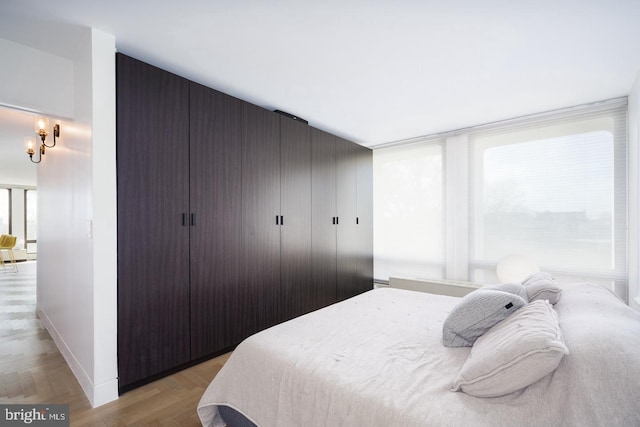 bedroom featuring light parquet flooring