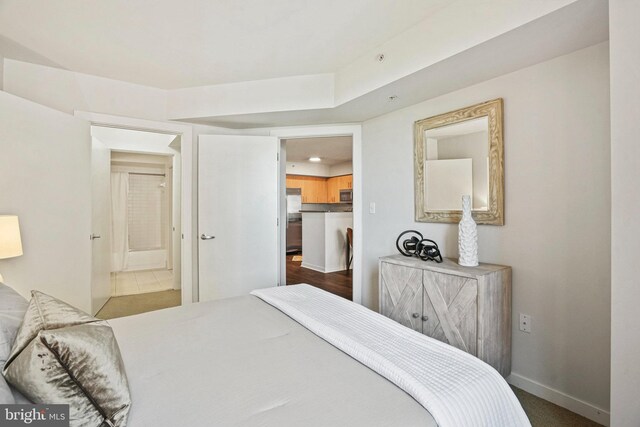 carpeted bedroom featuring stainless steel refrigerator