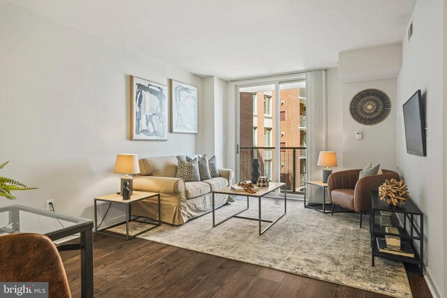 living room featuring dark hardwood / wood-style floors and expansive windows