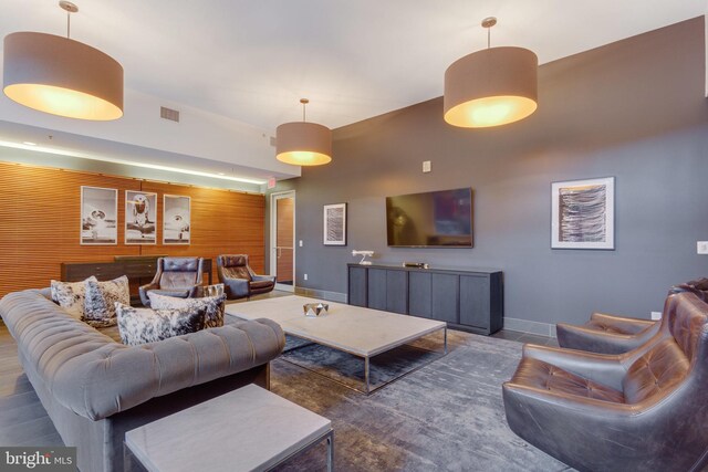 living room with wood walls