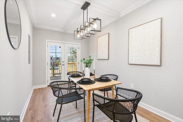 dining area with beam ceiling, french doors, a notable chandelier, light wood-type flooring, and ornamental molding