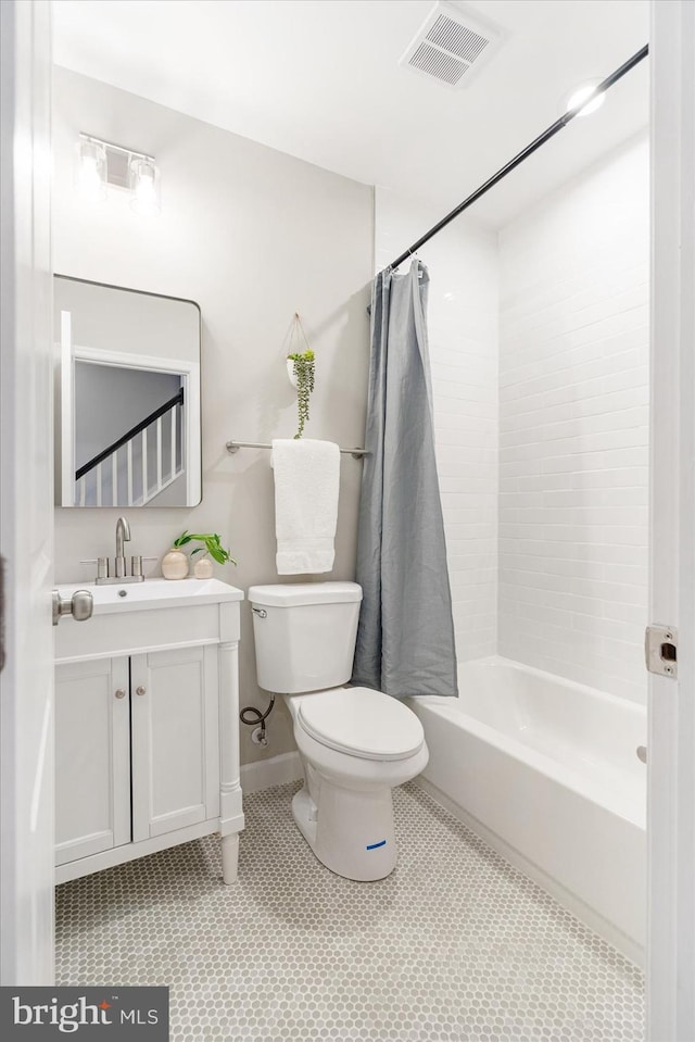 full bathroom with toilet, shower / bath combo, vanity, and tile patterned floors